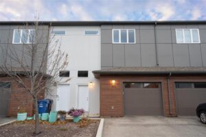 Modern two-storey Fairfield Park townhouse with attached garage and south-facing deck in Winnipeg
